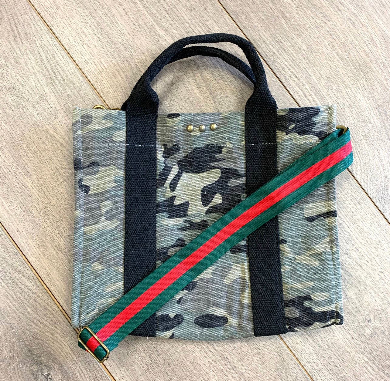 Our new PS canvas totes are the perfect size for everyday use. They are the perfect accessory to top off any outfit! Material: Cotton Canvas. Measure: 10 inches x 12.25 inches x 6 inches. The removable strap, measures 1.5 inches wide, extending to 40 inches. Each bag has a magnetic closure, and one small inside pocket.