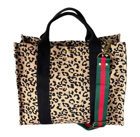 Our new PS canvas totes are the perfect size for everyday use. They are the perfect accessory to top off any outfit! Material: Cotton Canvas. Measure: 10 inches x 12.25 inches x 6 inches. The removable strap, measures 1.5 inches wide, extending to 40 inches. Each bag has a magnetic closure, and one small inside pocket.