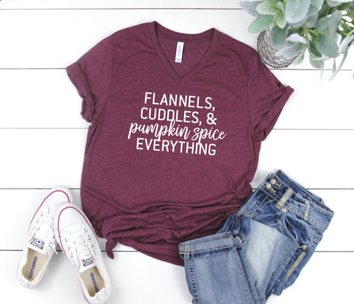 Flannels, Cuddles, and Pumpkin Spice Tee. This updated unisex tee essential fits like a well-loved favorite, featuring a classic V-neck, short sleeves and superior combed and ring-spun cotton. JLD is super excited to customize your new fall tee!   Choose your shirt size, color, and your art color to make this perfect fall tee your own! 