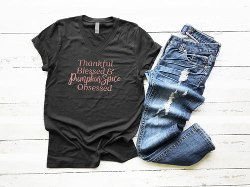 Thankful, Blessed, and Pumpkin Spice Obsessed Unisex V Neck Tee.  This updated unisex tee essential fits like a well-loved favorite, featuring a classic V-neck, short sleeves and superior combed and ring-spun cotton. JLD is super excited to customize your new fall tee! 